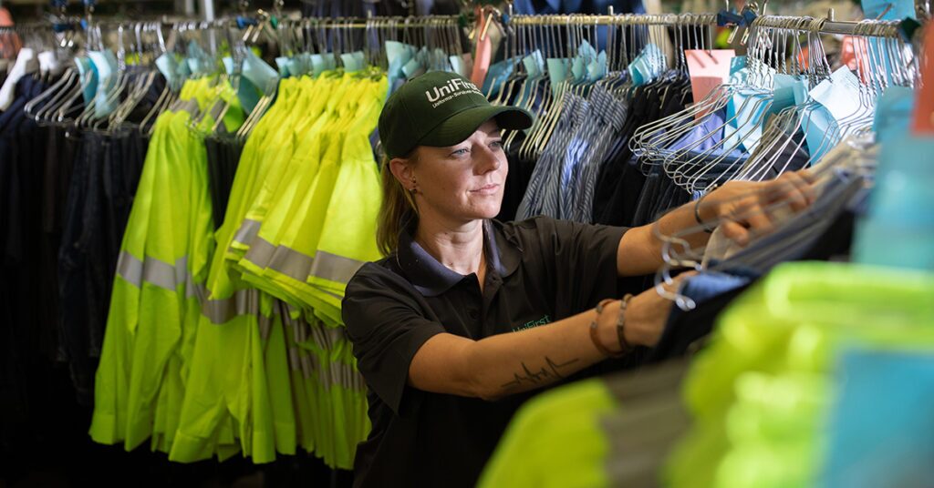 UniFirst Team Partner maintaining high visibility workwear at a UniFirst location.