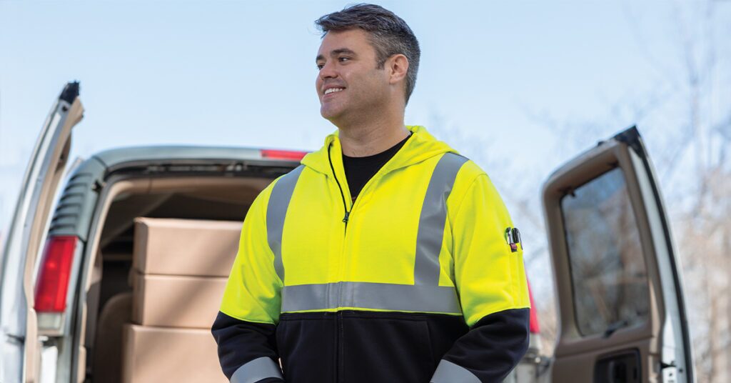 Worker wearing a high visibility hoodie at a job site