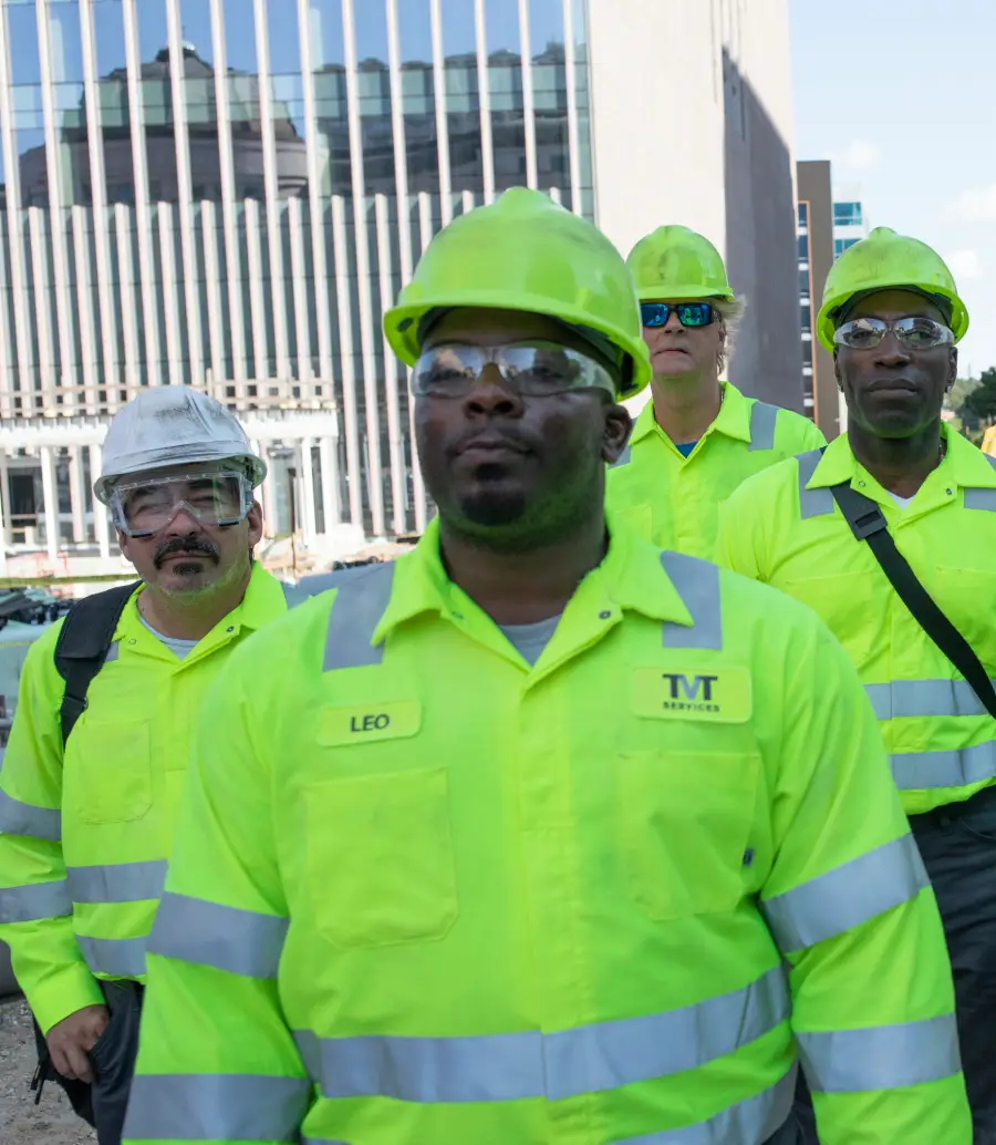 Contracting and trades workers walk together at their work site wearing UniFirst high visibility safety workwear