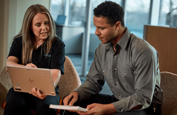 A UniFirst representative meets with a customer and discusses service