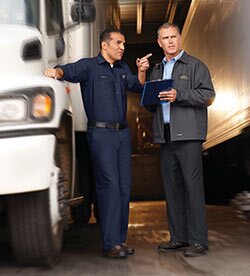 Employees wearing a variety of UniFirst color branded uniforms