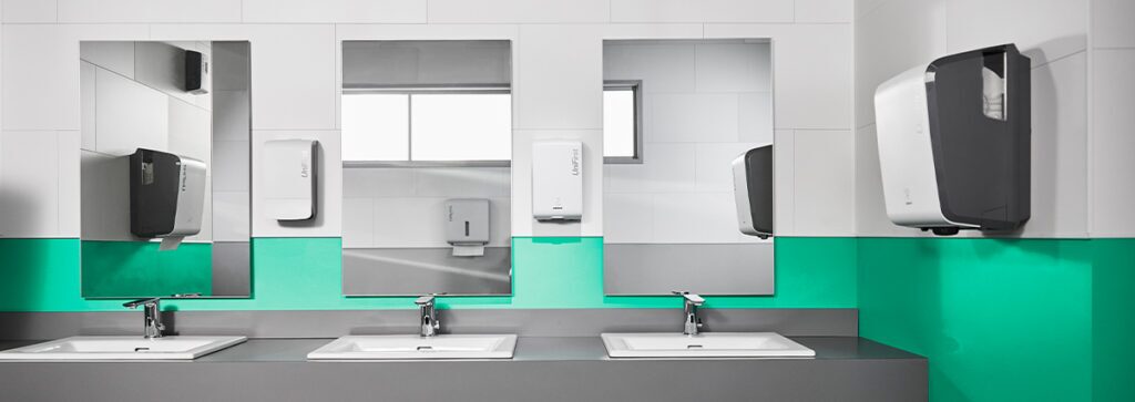 An image of a public restroom show ADA compliant paper towel dispensers